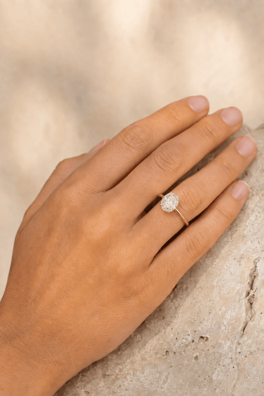 Oval diamond solitaire engagement ring in a gold setting